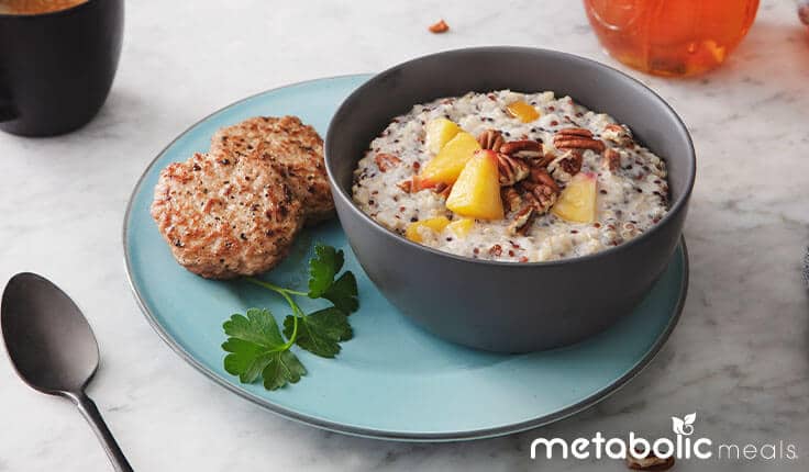Oatmeal and turkey sausage breakfast meal on table.