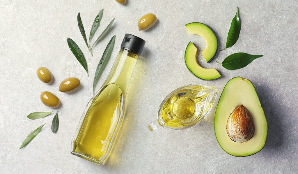 Image of healthy oils - olive oil and avocado oil. 